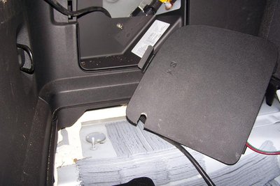 Pullback shot of car mods, switch and slot in cover plate for the AC wire