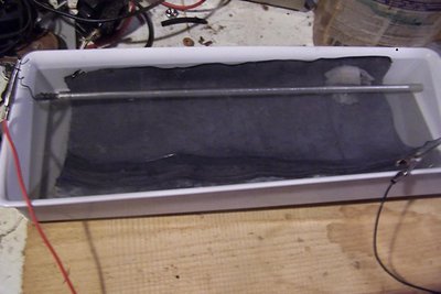 I just used a tilted tray to avoid having to mix up too much electrolyte, and a piece of lead foil as the cathode.  If you use Al for the cathode, you have to remove it when not in use - it will dissolve over time.