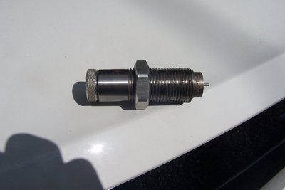 Assembled.  The shell holder on the press pushes the collet up to squeeze just the case neck against the guide rod.