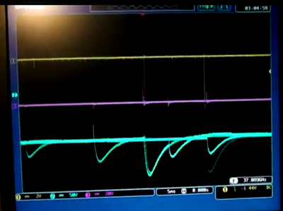 A frame from the youtube movie above that shows something interesting.  FWIW, the scope is actually on the cart on the "hot side" of the shielding, near the signals in question, and running 5ms/div I believe.