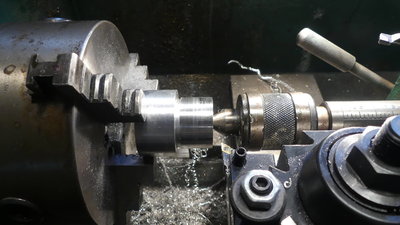Part turned down to the desired OD for threads, a nd a gutter cut for the threading tool to run out into.