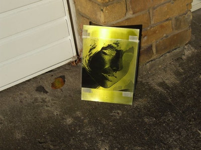 It is then washed in distilled water, coated with photosensitive ink (aerosol) and baked in the dark.<br />The aluminium sheet is covered by a negative of the image (printed on transparency with a laser printer) and is exposed to UV light, in this case, the weak autumn sun.