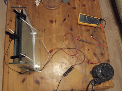 The completed image is washed and left to dry, ready for anodising.<br />The tank is filled with dilute sulphuric acid.<br />A lead sheet of similar size to the aluminium is cleaned, to expose the surface, and it is placed into the tank as a cathode.<br />The aluminium plate is then emersed into the tank to create the anode (hence 'anodising'). 4 amps at 12 volts is passed through the acid for 45 minutes, this heats up the acid and gives off hydrogen.