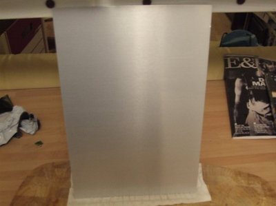 The aluminium is then removed and washed in distilled water, and then the remaining unexposed photosensitive ink is washed off with acetone. Once the anodised sheet has been washed in acetone, prior to dyeing, no image is visible.